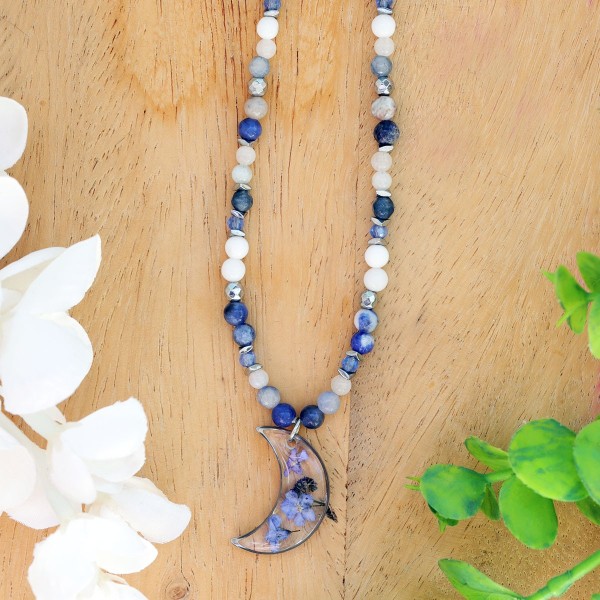 Moon necklace full of stones with forget-me-nots
