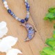 Moon necklace full of stones with forget-me-nots