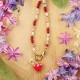 Necklace with a heart pendant and a spirea flower
