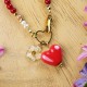 Necklace with a heart pendant and a spirea flower