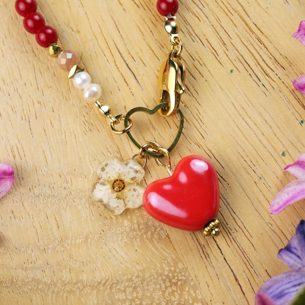 Necklace with a heart pendant and a spirea flower