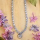 Necklace full of stones with forget-me-not