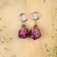 Earrings with embedded rose buds